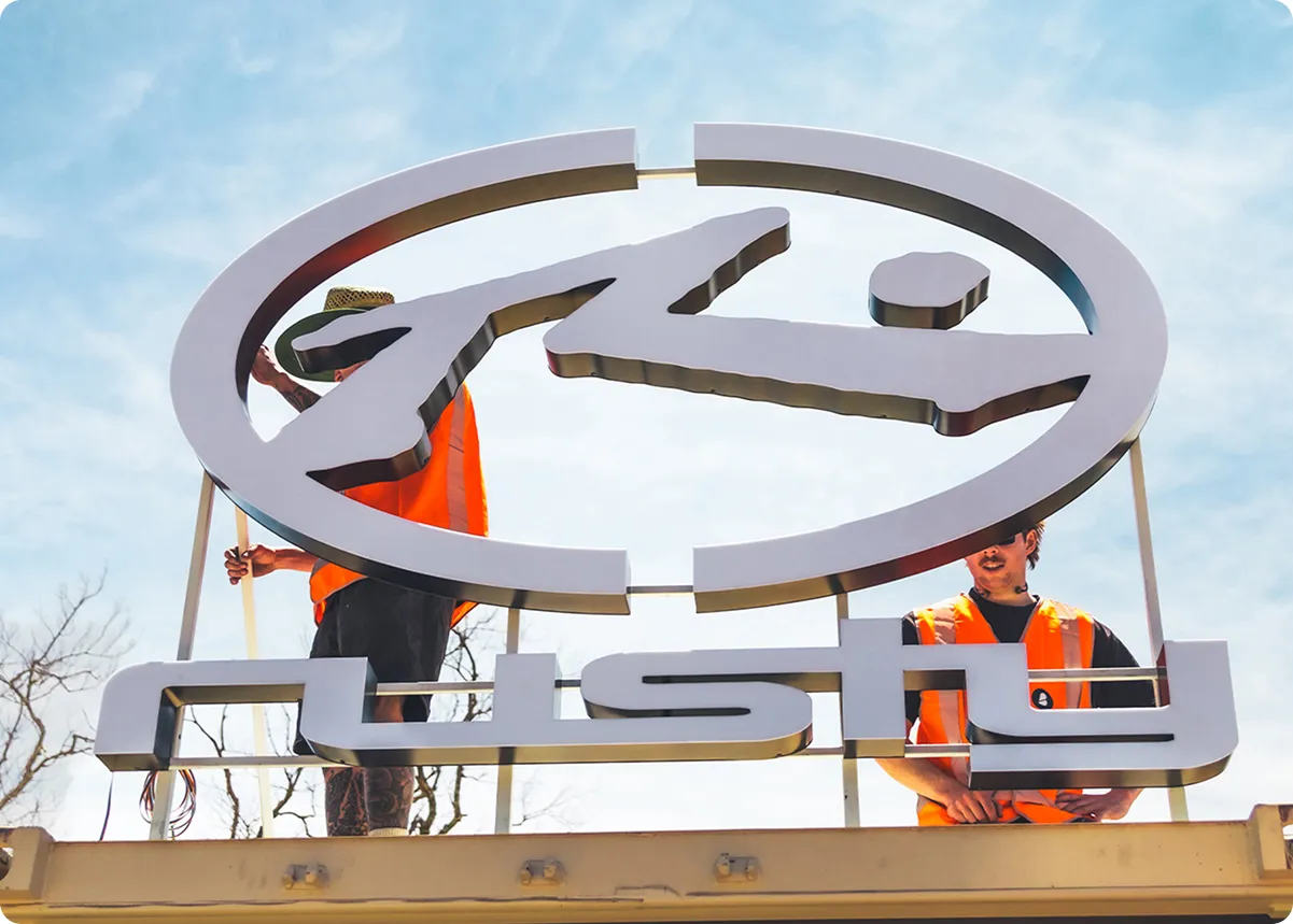 Rusty signage installation against a blue sky