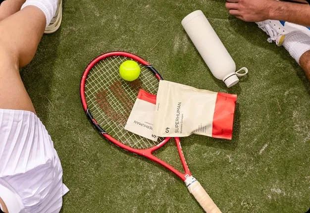 Tennis racquet and ball on grass